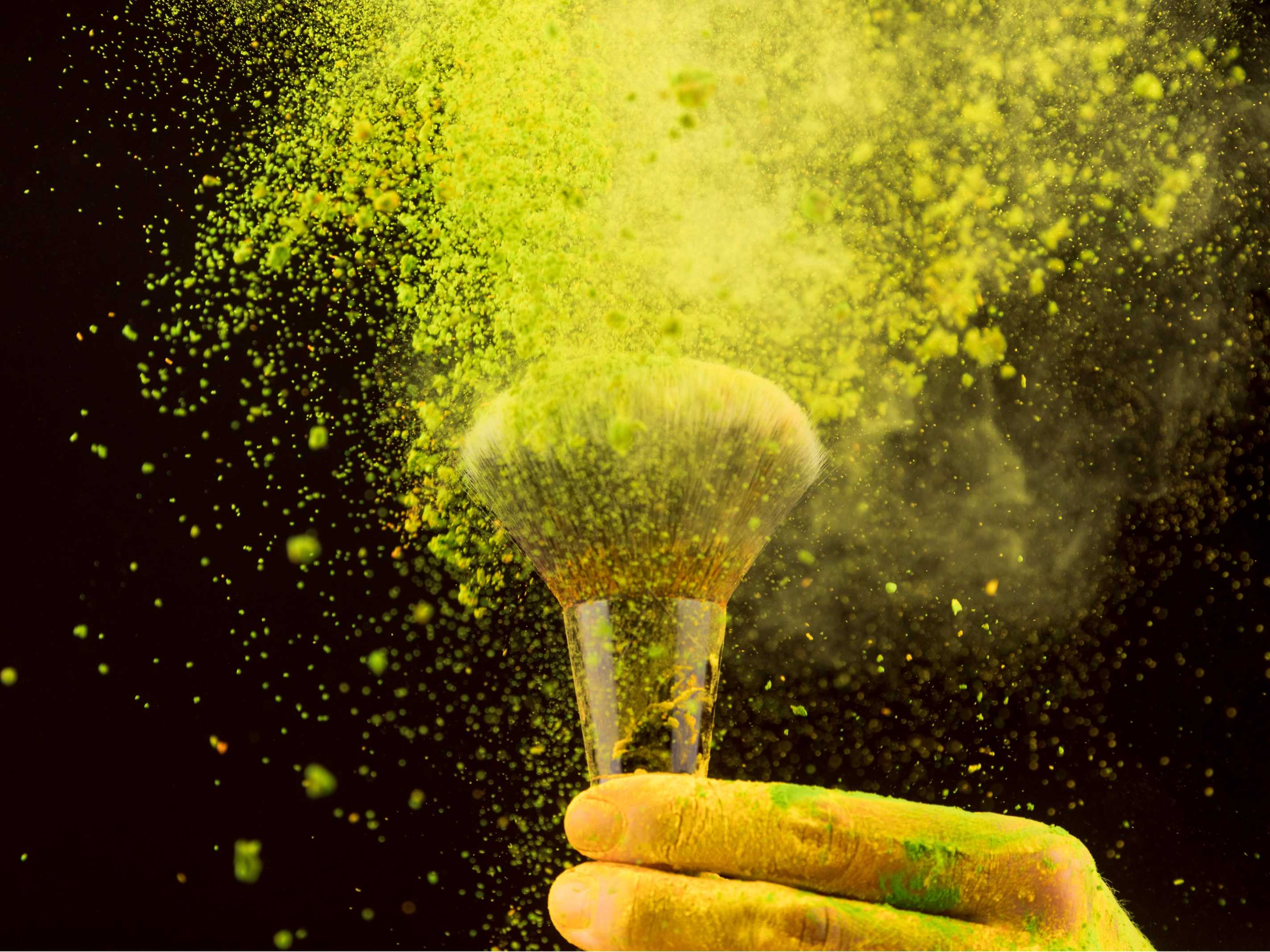 explosion-yellow-powder-with-makeup-brush-dark-background(1).jpg